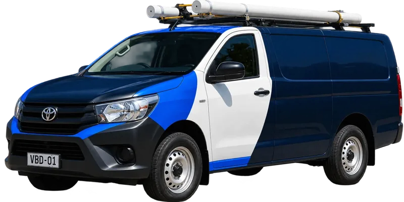 A licensed Killara plumbing van loaded with pipe on the roof rack